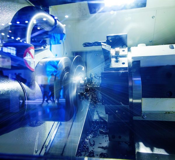 metalworking industry: finishing metal working on lathe grinder machine with flying sparks